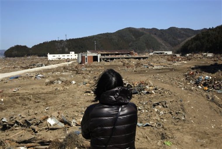 An unidentified mother who lost her children stands in front of Okawa Elementary School devastated by the March 11 earthquake and tsunami, in Ishinomaki, Miyagi Prefecture, northern Japan. The March 11 tsunami killed 74 of the 108 students at Okawa Elementary School and all but one of the dozen teachers.